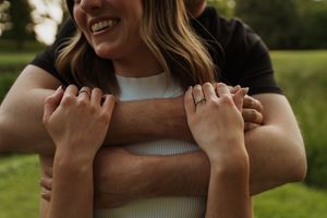 Candid moment of joyful laughter during outdoor couples photoshoot.