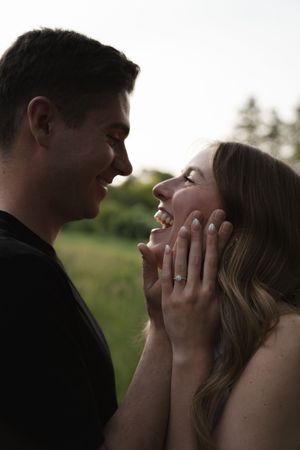 A romantic silhouette of two people sharing an intimate moment at sunset.