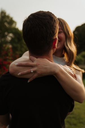 Intimate moment captured between couple during golden hour in nature setting.