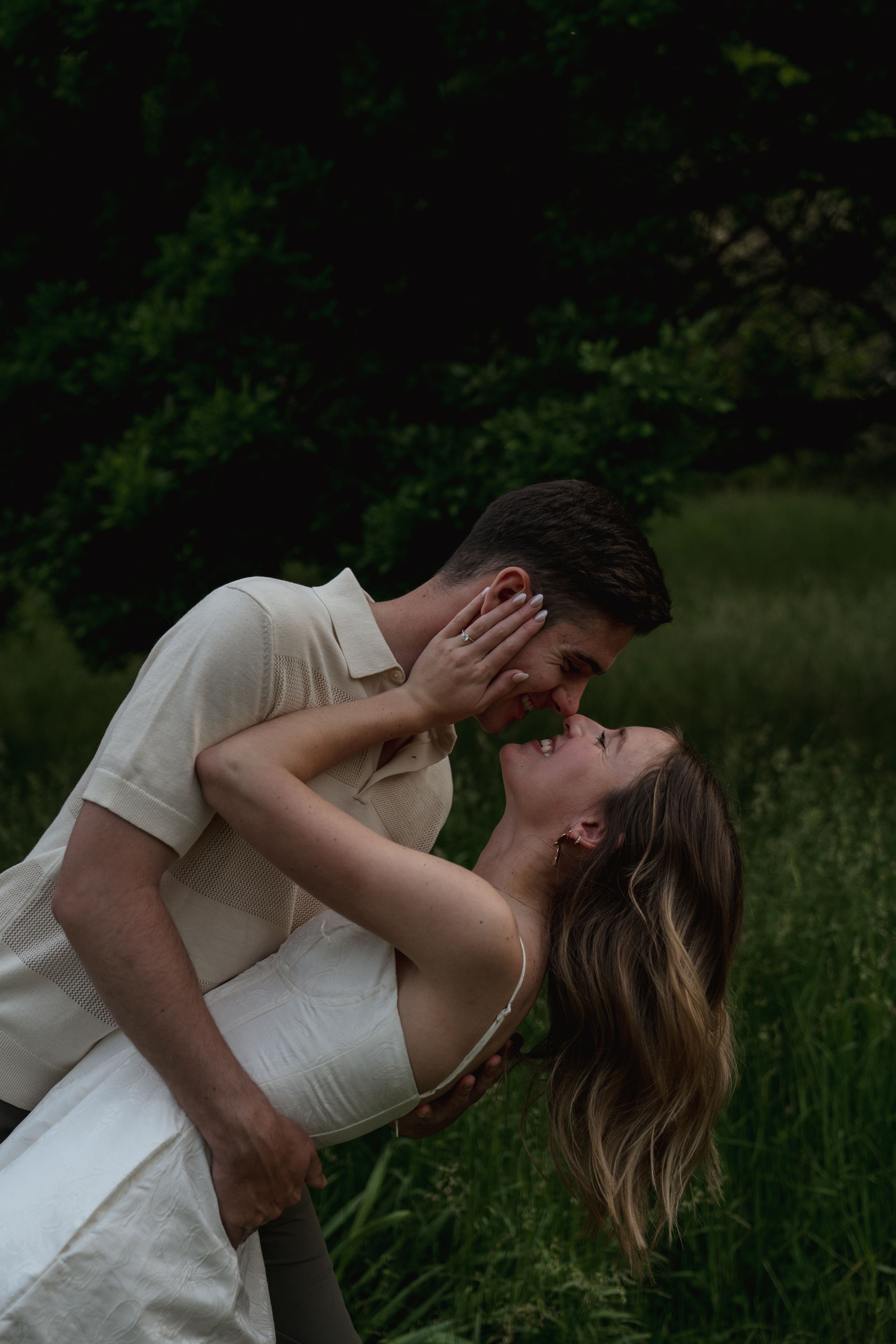 A romantic dip pose captured in a natural outdoor setting.