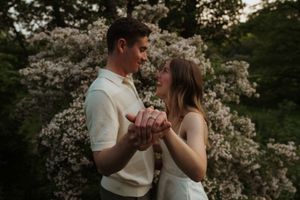 A romantic spring portrait with blooming flowers in the background.