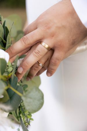 Bride and groom rings detail photos outside with bouquet in Springfield, Illinois