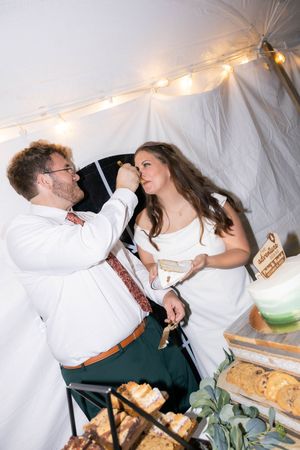 Bride and groom cake cutting reception photos in a tent in Springfield, Illinois