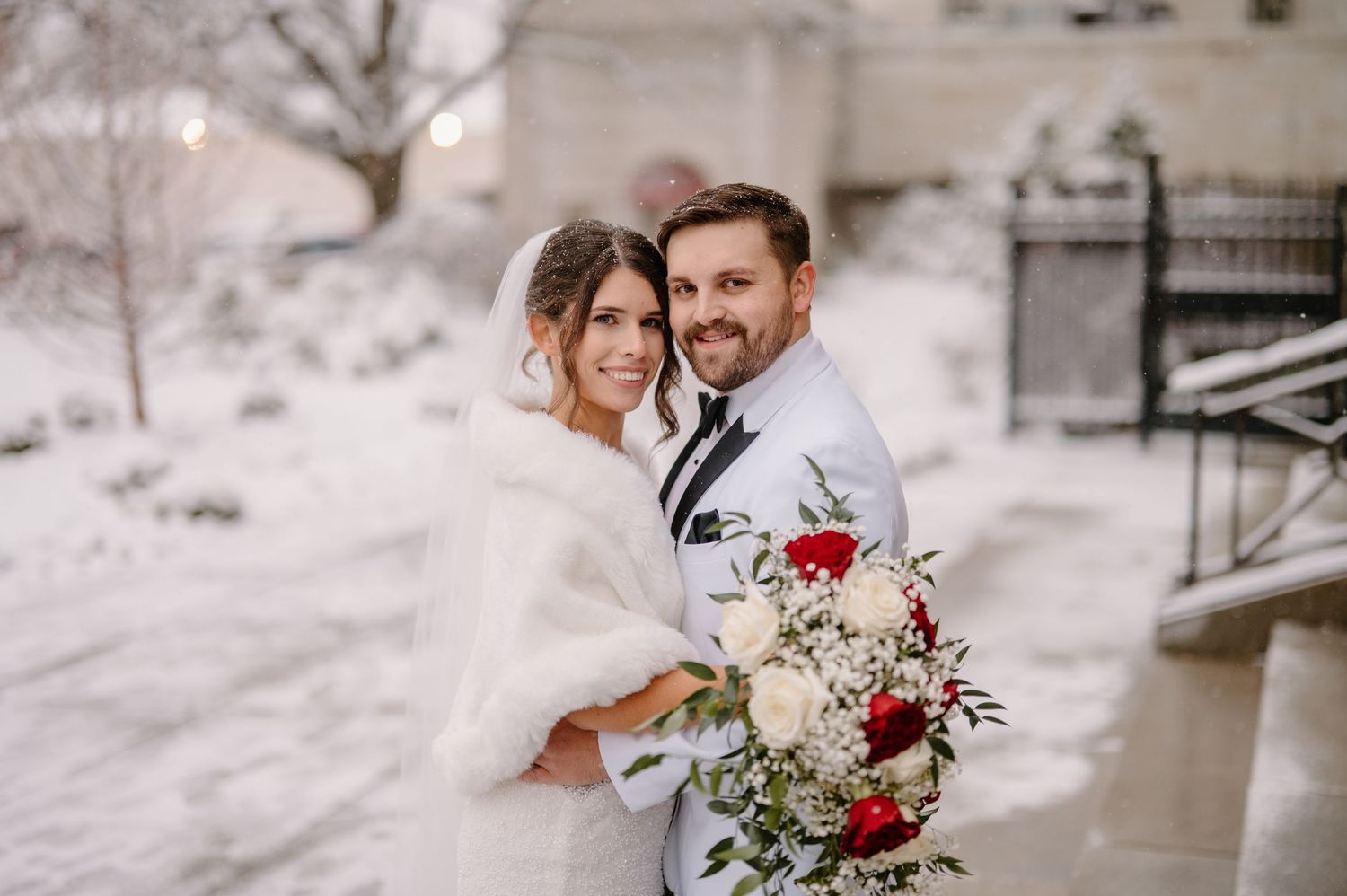 Cincinnati summer wedding portrait with soft golden lighting and green foliage.