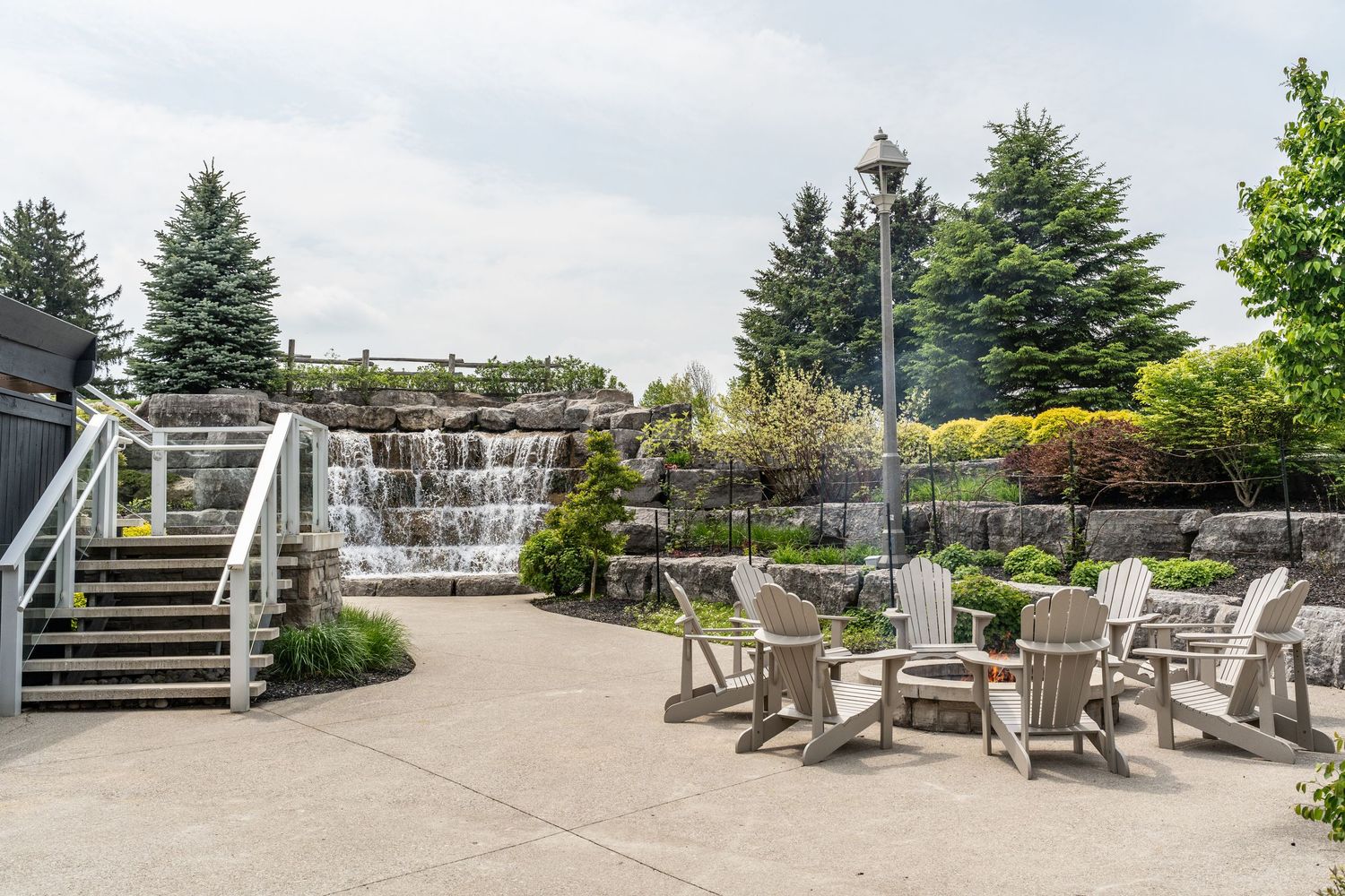 Outdoor terrace with Adirondack chairs overlooking a scenic landscape view at Whistlebear Golf Club.