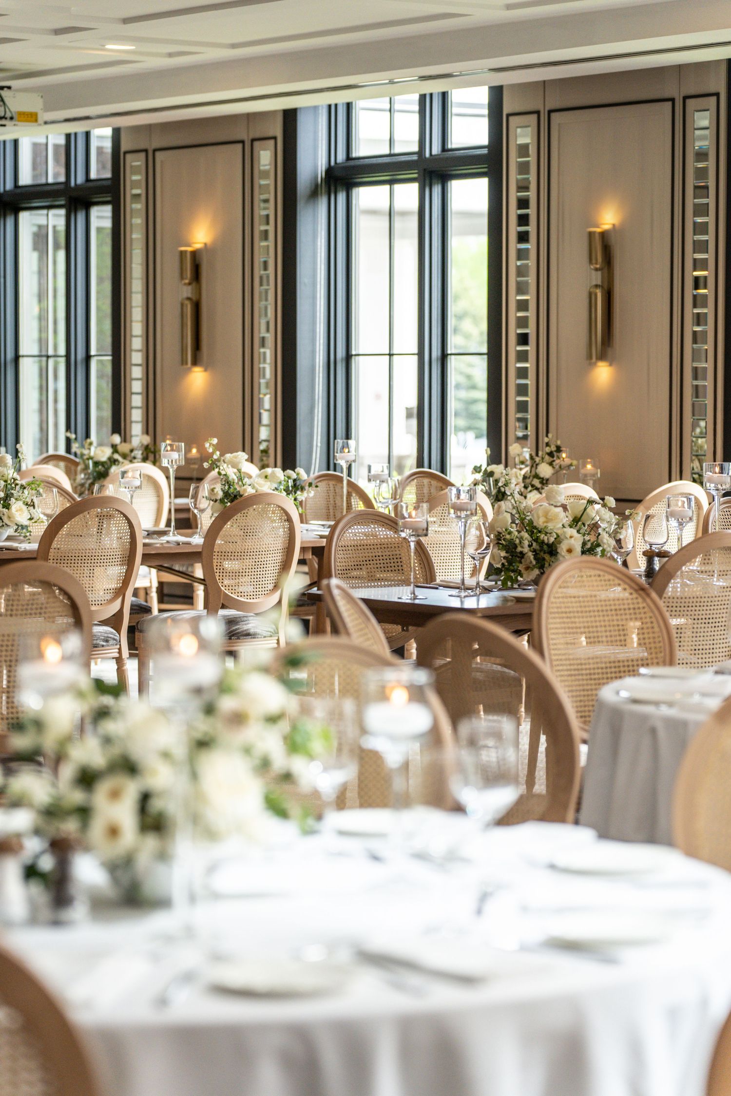 Luxurious banquet hall setup at Whistlebear Golf Club with round tables, elegant place settings and floral centerpieces.