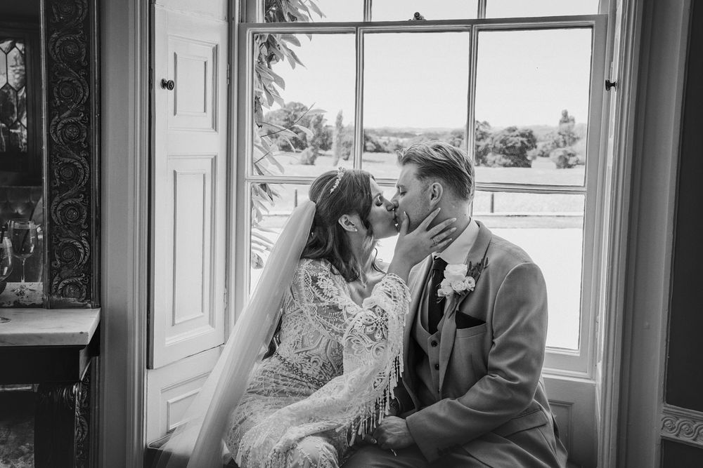 Bride and groom having a quiet moment inside Rockbeare Manor