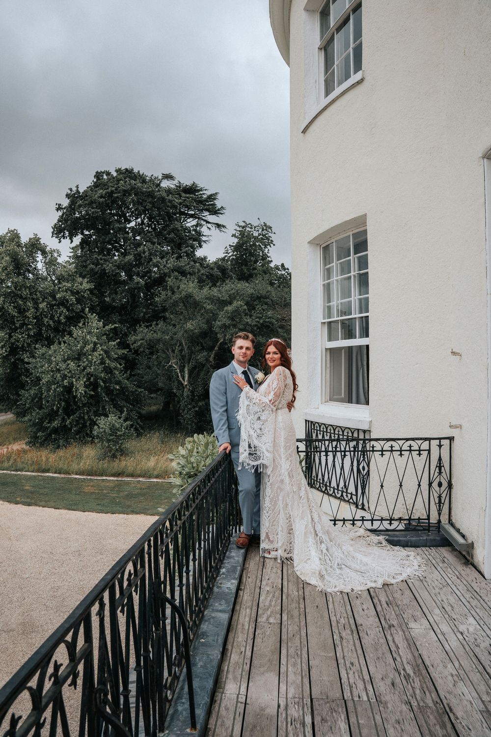 Bride and groom balcony portrait at Rockbeare Manor