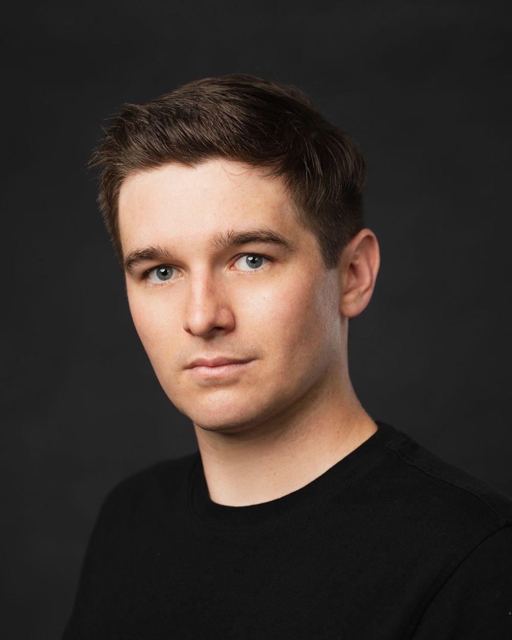 Portrait series showing person in black sweater against dark studio backdrop.