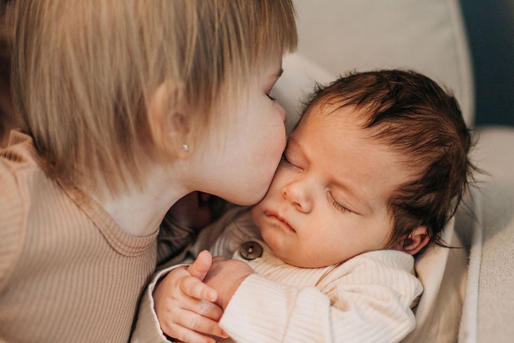 child kisses baby