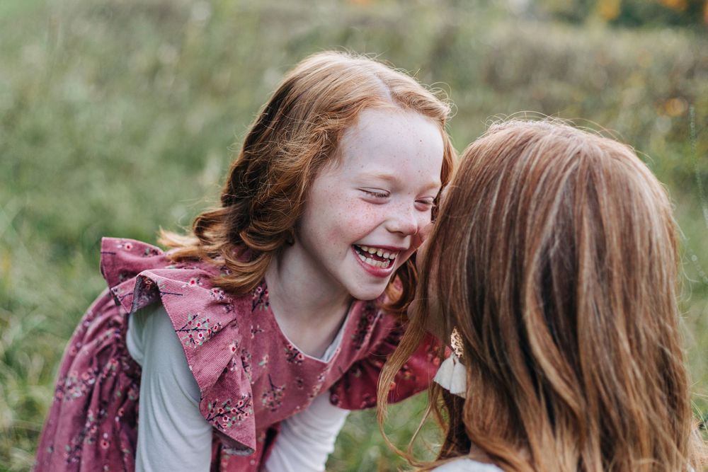 children smile in field