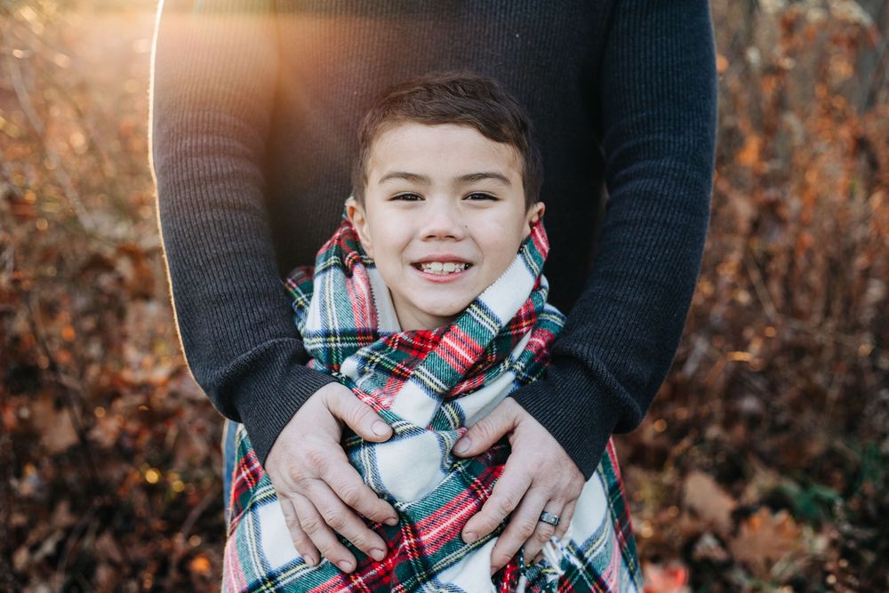 child wrapped in blanket in golden hour