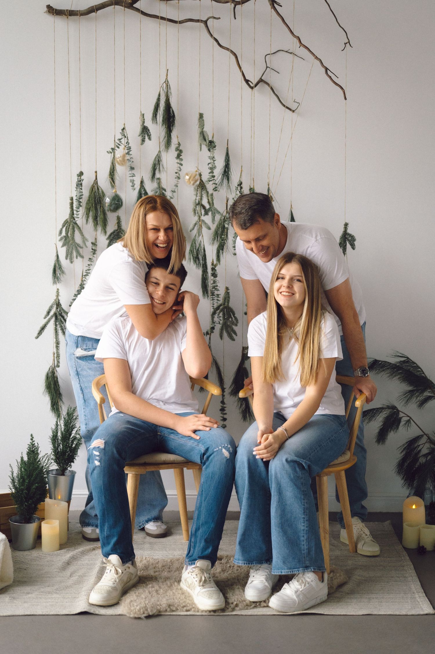 A casual photo sequence showing a couple sitting together and laughing on chairs against a wall decorated with pine tree art.
