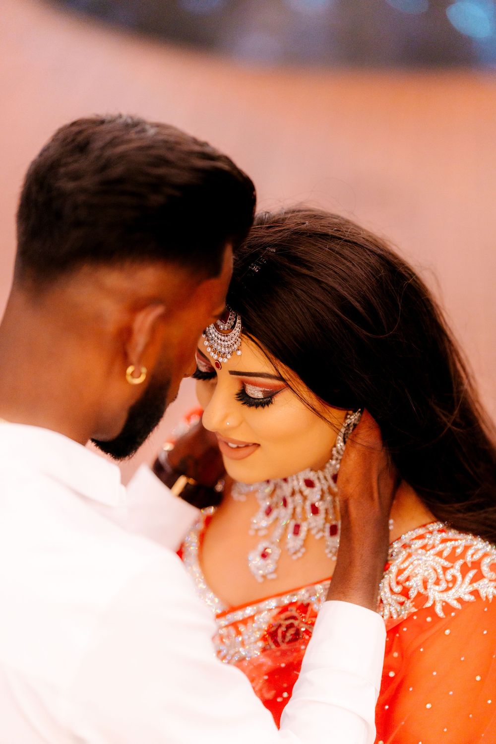 Romantic couple in traditional South Asian attire share intimate moments in a series of wedding photos.