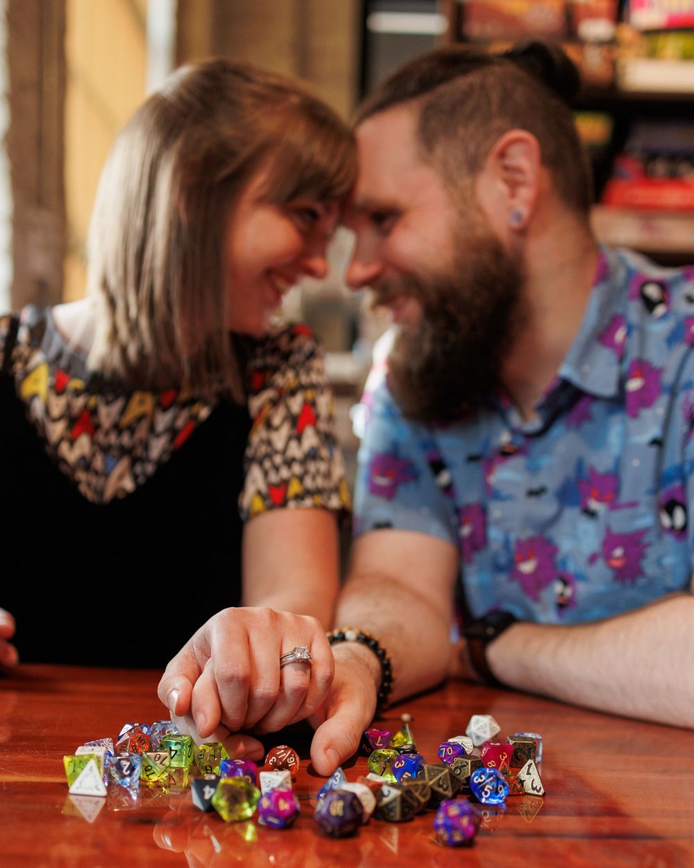 A collection of colorful gaming dice displayed in a sequence of close-up shots on a wooden table.