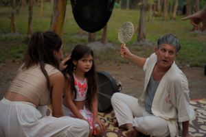 Group gathered around sharing stories in an outdoor garden setting.