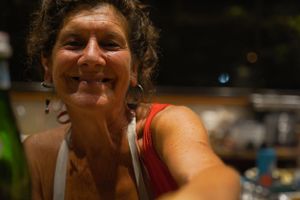 Close-up shot of person smiling warmly at camera in casual attire.