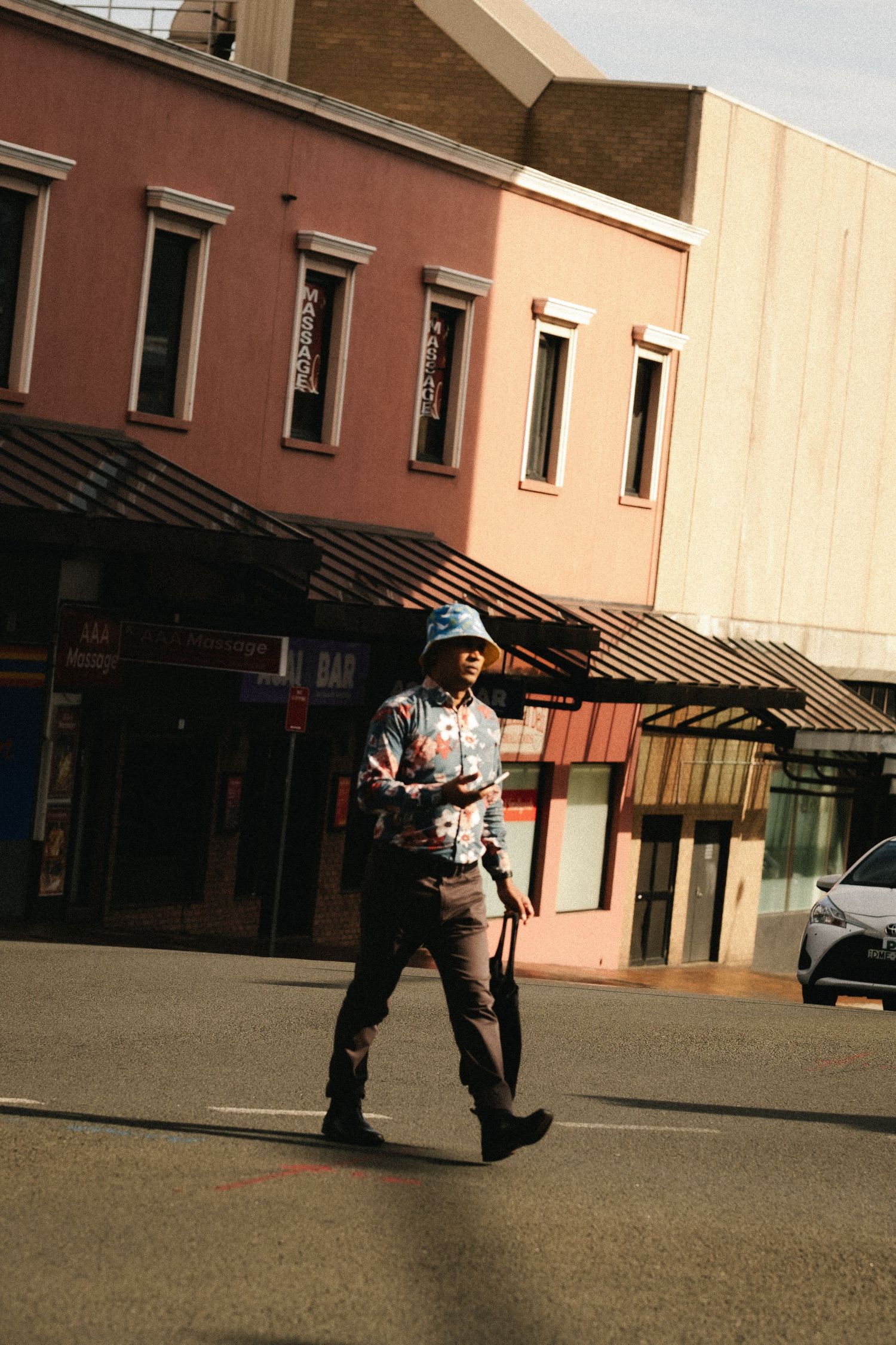A montage shows a security guard patrolling an empty outdoor plaza area during sunset hours.