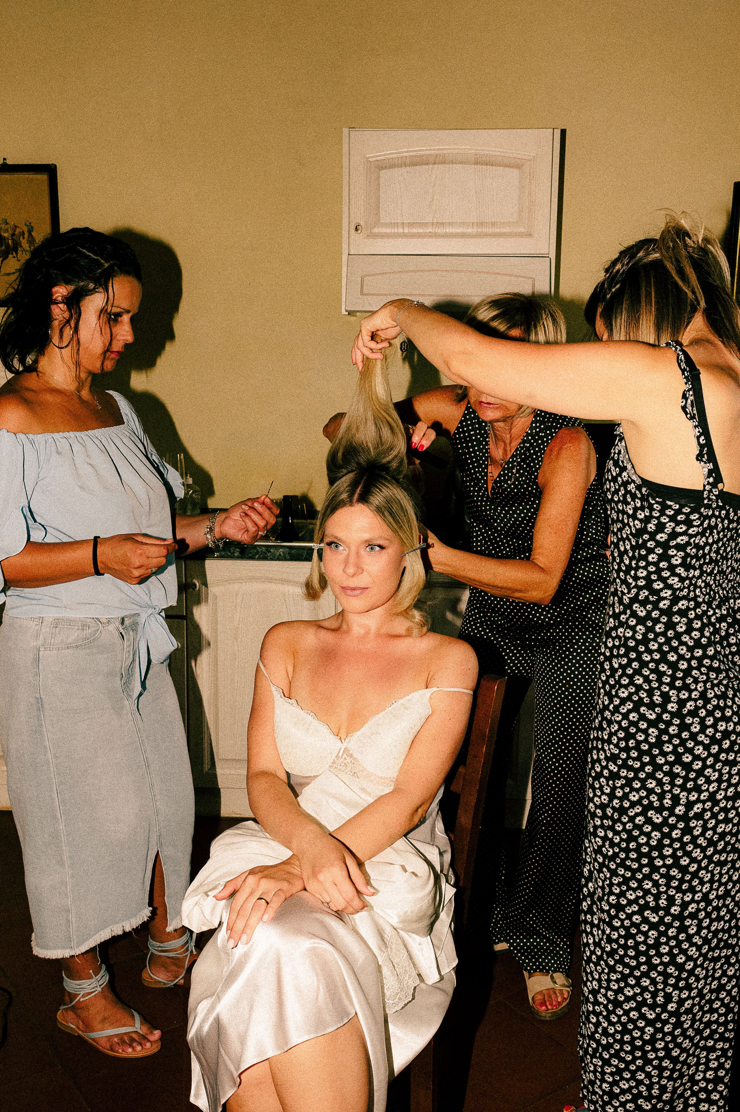 Wedding preparation scene showing final touches being made indoors.