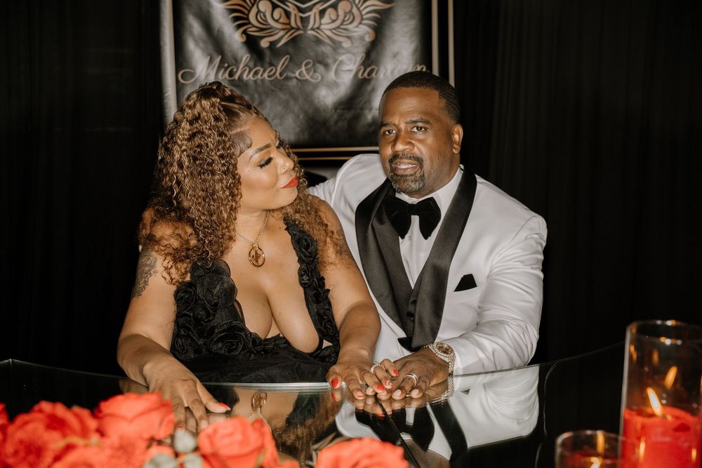 A well-dressed couple shares intimate moments at an elegant candlelit dinner celebration.