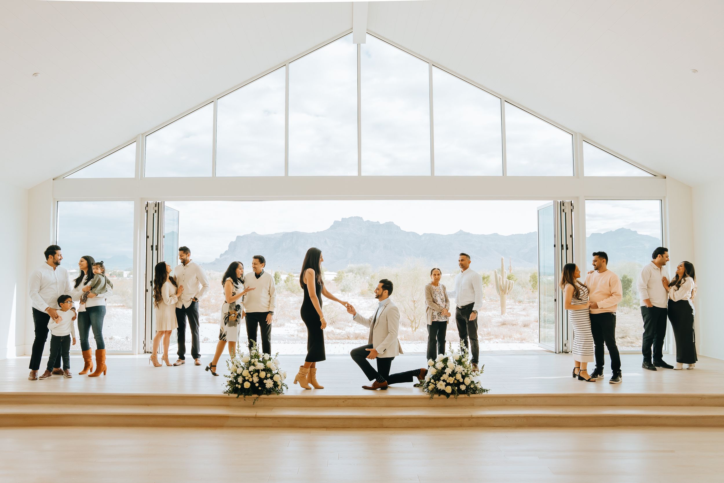 Sequential proposal photos in a minimalist white chapel with panoramic mountain views.