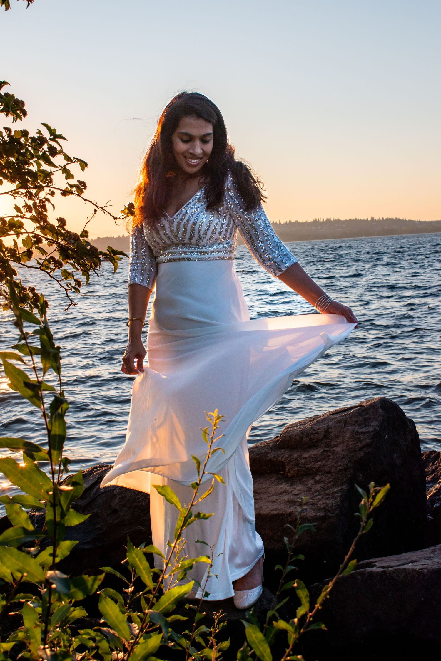 Creative outdoor portrait of a woman in a white dress during a sunset photo session near Seattle.