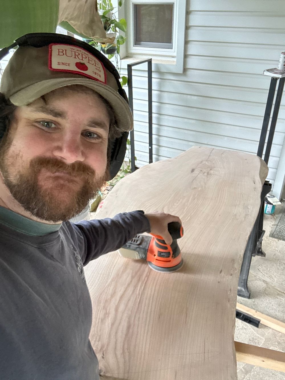 A series of selfies showing woodworking progress on a light-colored wooden surface.