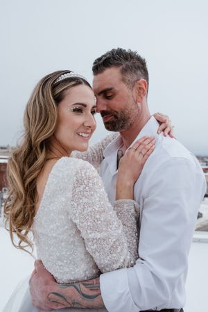 Intimate winter wedding portrait with sparkly long sleeve dress.
