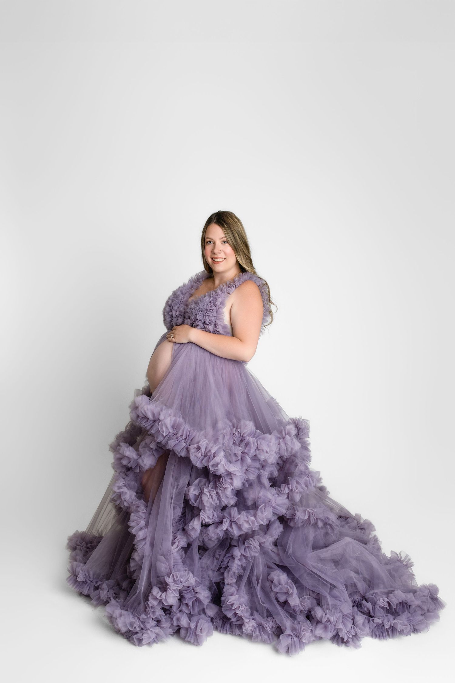 A lavender tulle gown with ruffled details flows elegantly across five poses against a white studio backdrop.