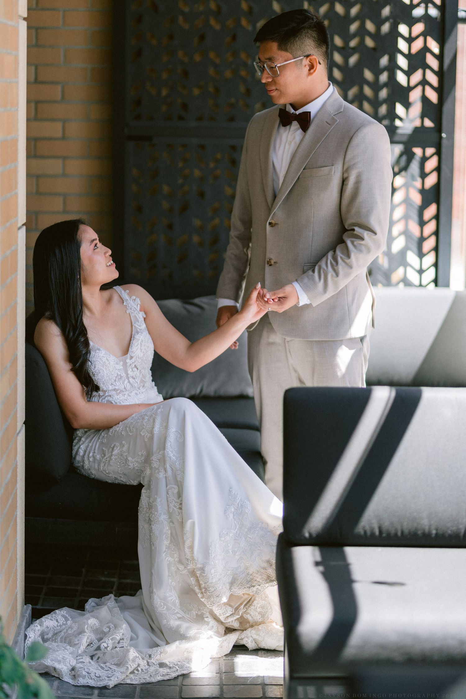 An intimate wedding moment captured in an architectural setting with modern decor.