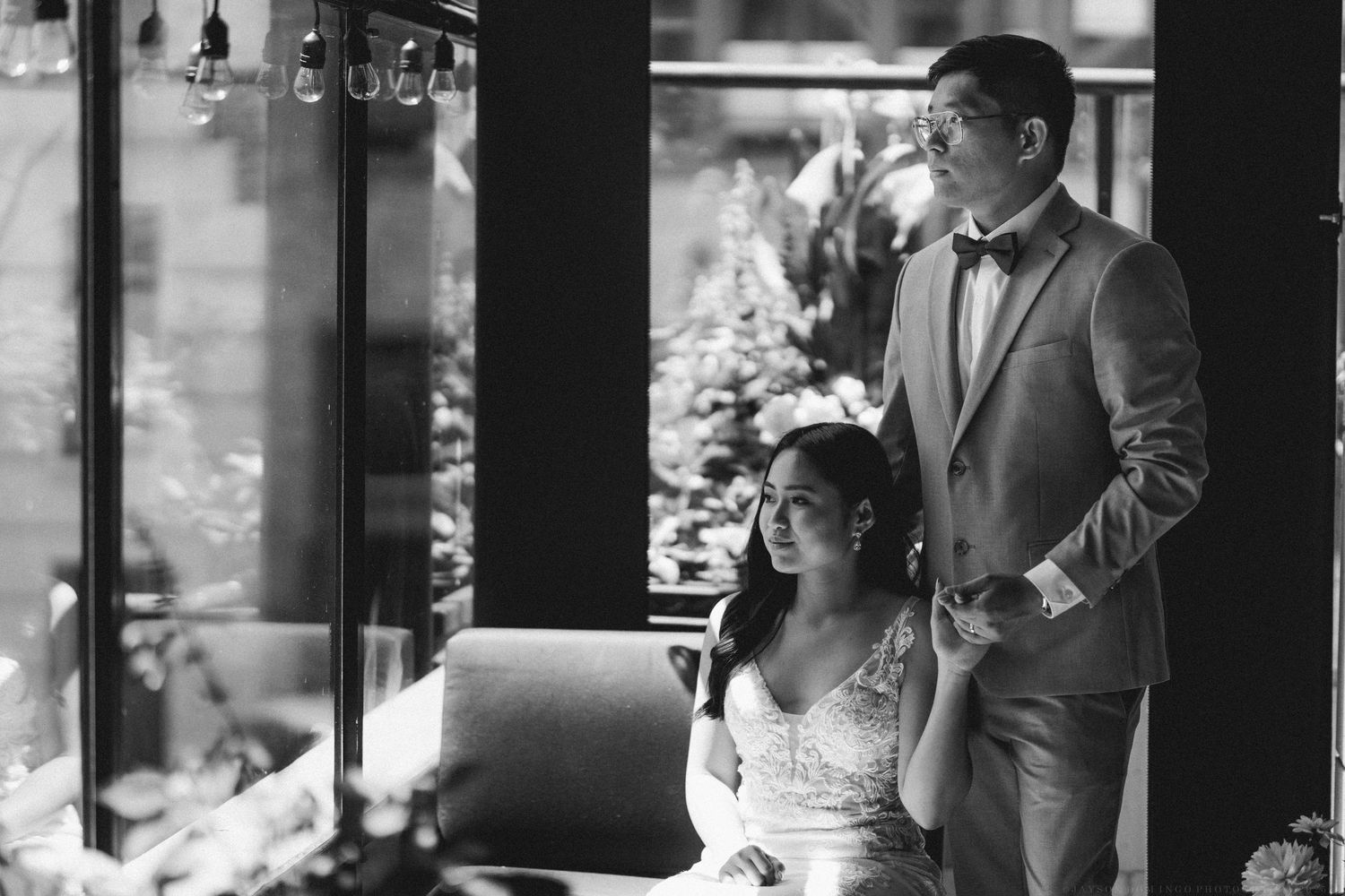 Black and white wedding photo in an elegant indoor setting.