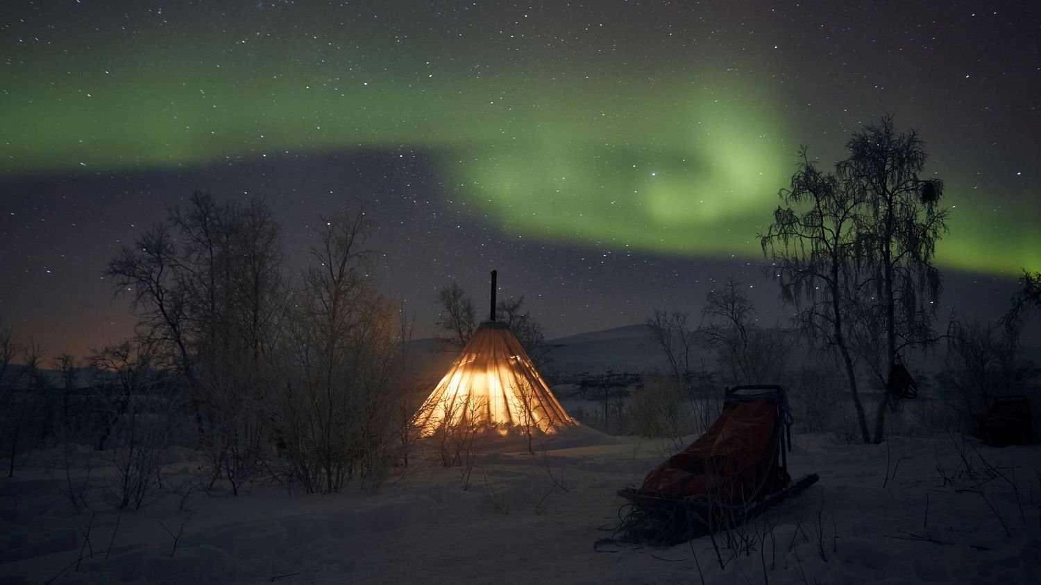 Landscape photography: Winter camping in a Sami tent with the Northern Lights, in northern Norway. Photo by Dayle Prowse.