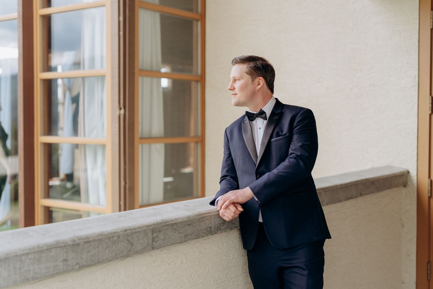 Interior wedding venue with wood-framed windows and natural light.