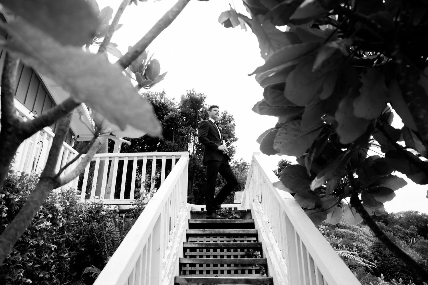 Wedding arch and floral arrangements frame a scenic outdoor ceremony setting.