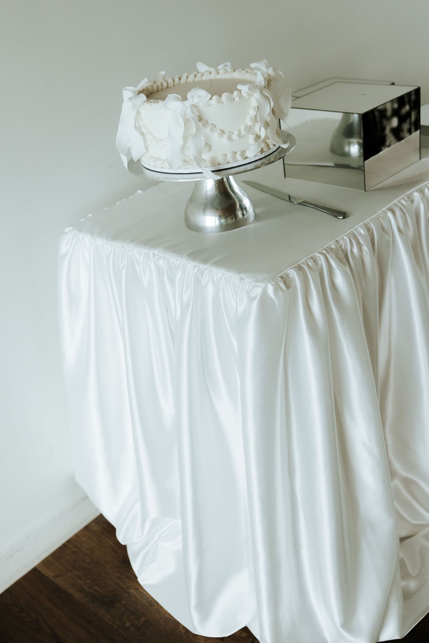 White tablecloth drapes elegantly over wedding reception table setup.