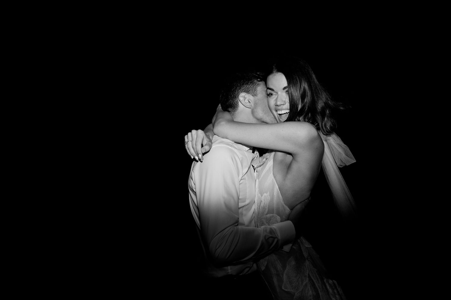 Intimate low-light dance photos capturing romantic wedding moments.