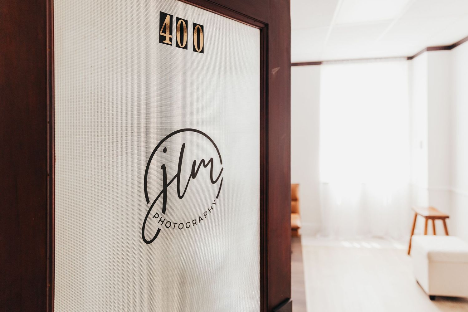 Film production company logo displayed on frosted glass office door with room interior visible.