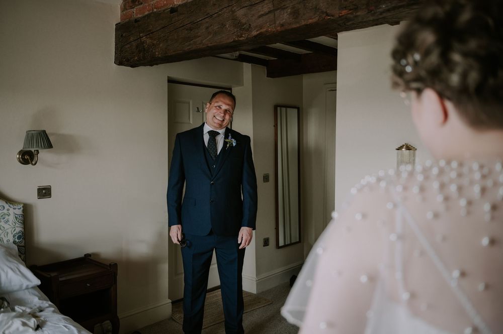 Father of the bride admiring his daughter during first look, head bent in emotion, Donington Park Farmhouse wedding.