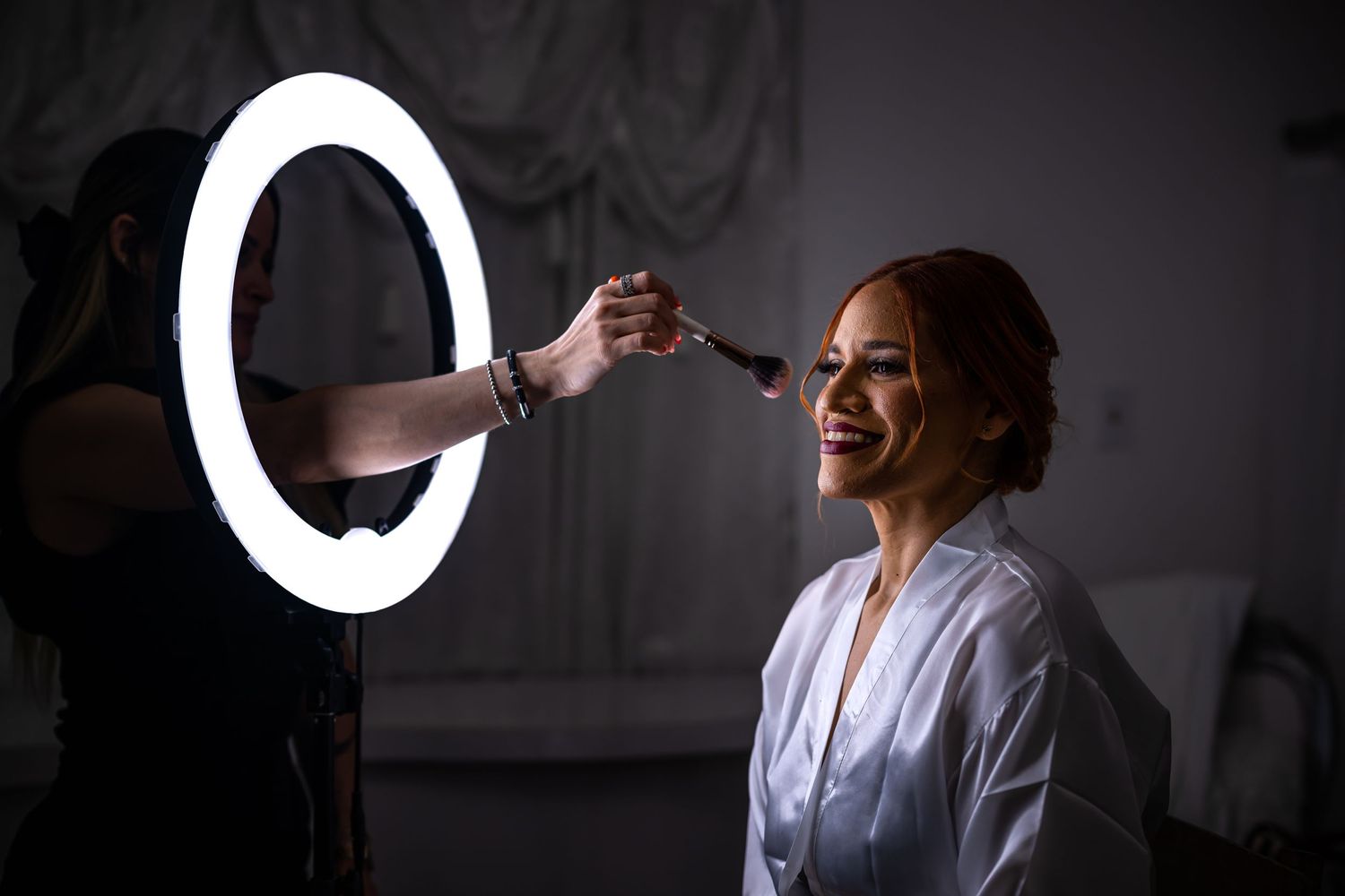 Professional photography setup with ring light during bridal preparation.
