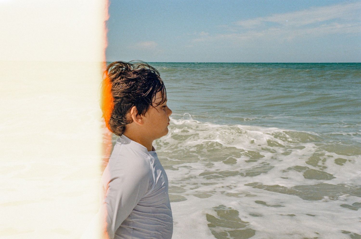 Seaside view with waves crashing on beach in natural lighting.