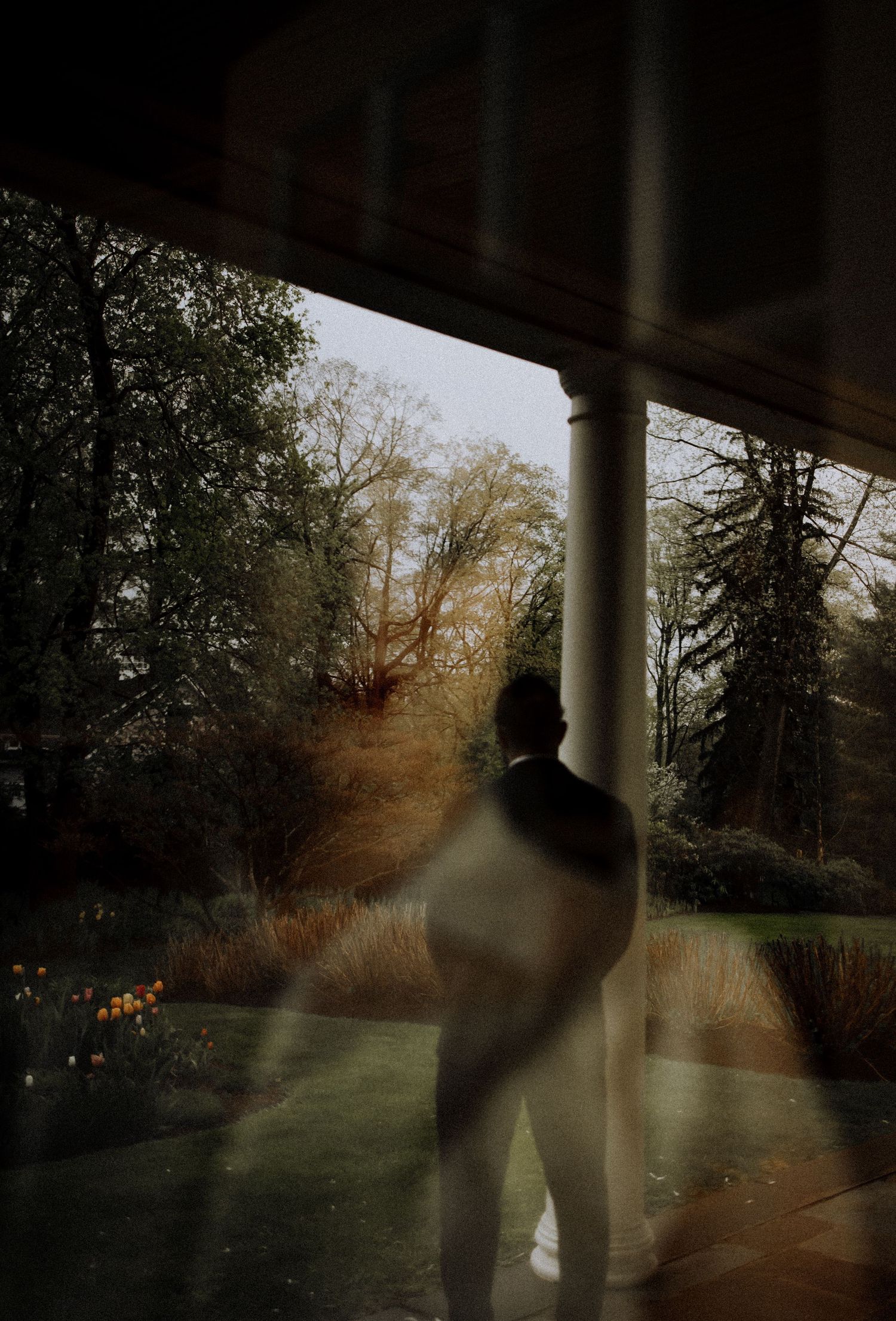 Silhouette figure standing by column with misty autumn landscape beyond in PA.