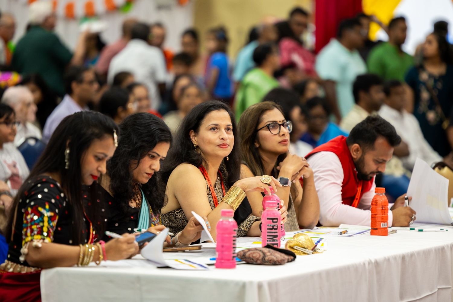 Long table filled with attendees at a community or educational event.
