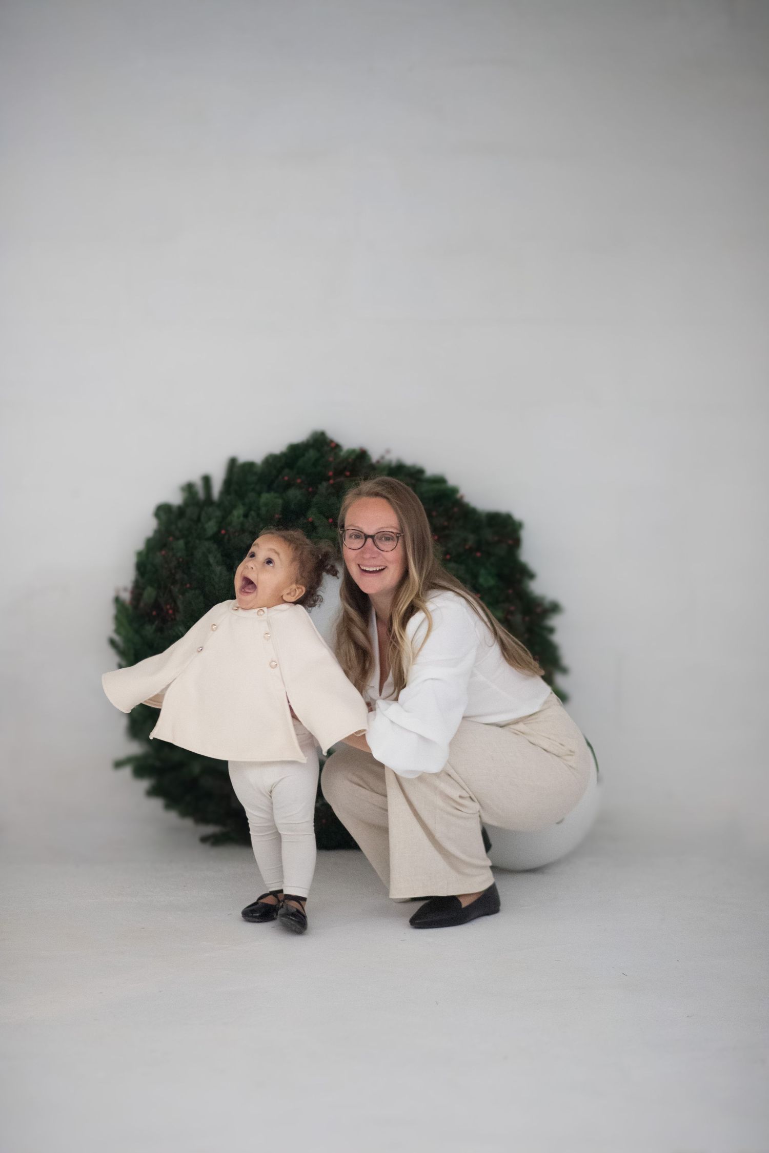 Mom and Baby in studio Christmas wreath portrait