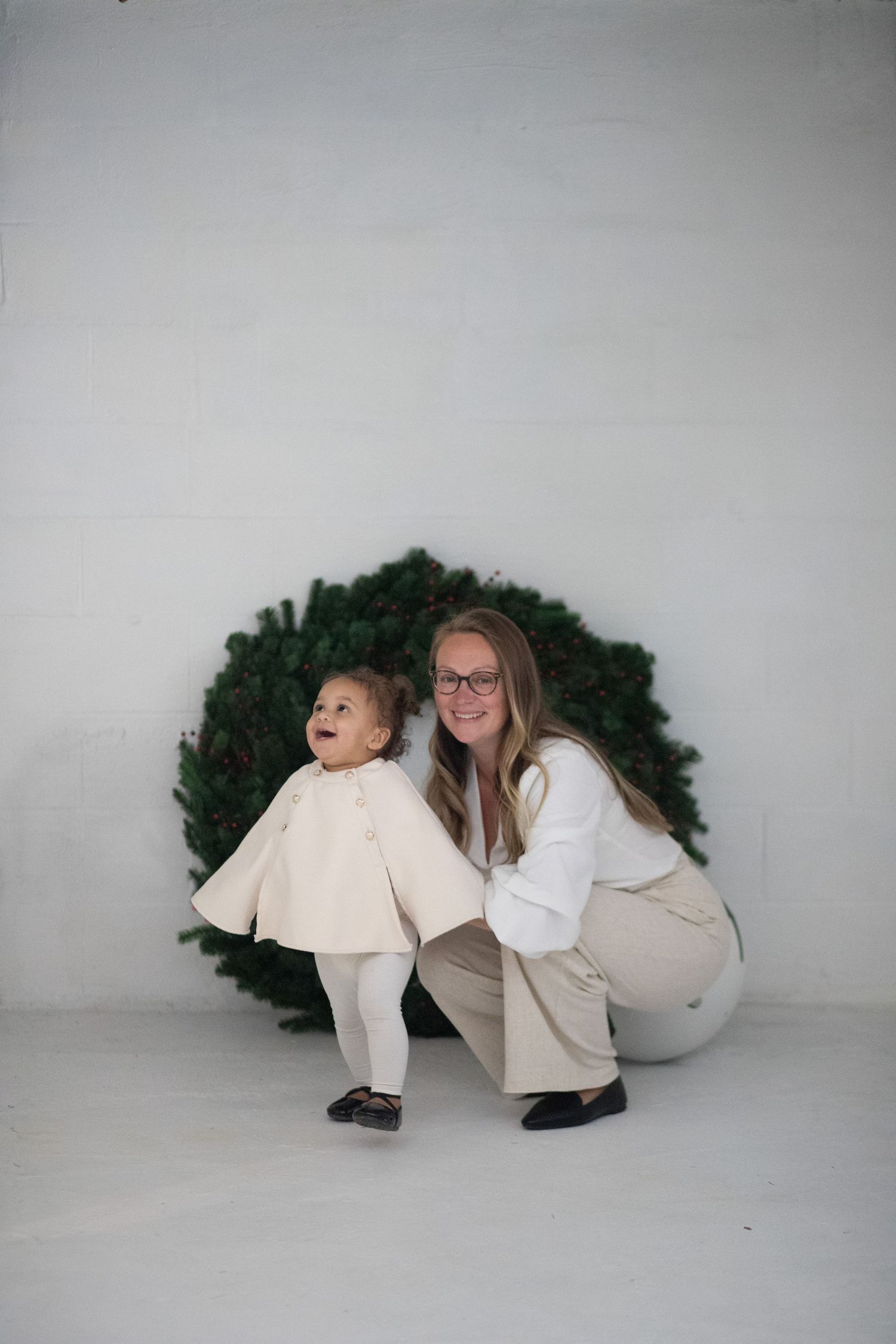Mom and Baby in studio Christmas wreath portrait