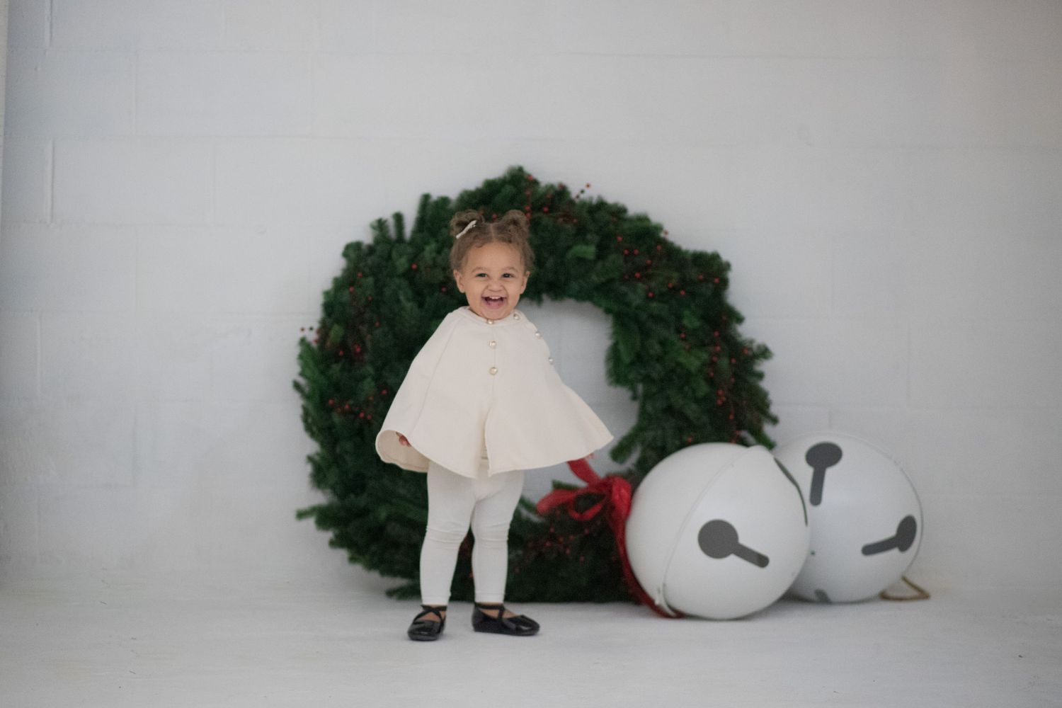 Baby in studio Christmas wreath portrait