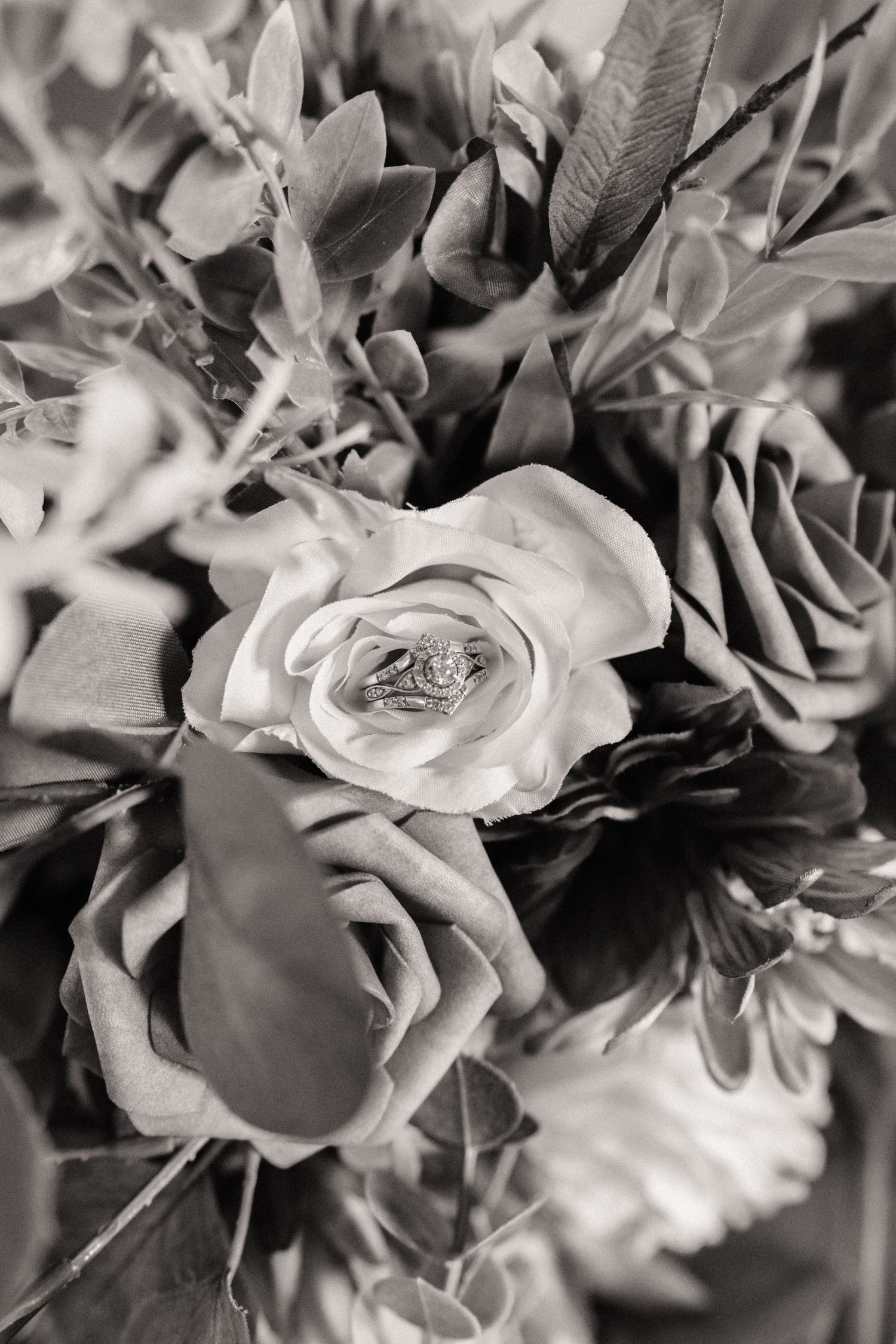 Black and white close-up of romantic rose bouquet with soft focus petals.