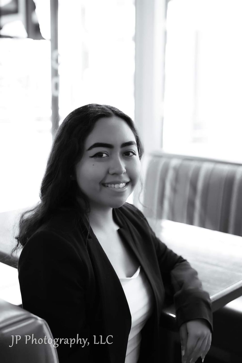 Professional black and white portrait of a person in business attire.