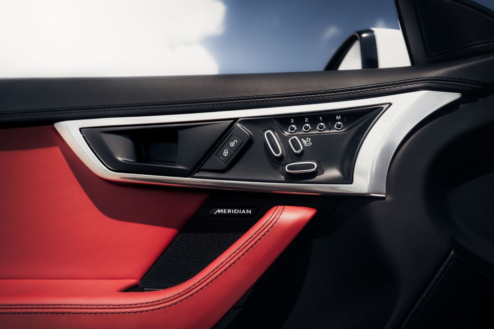 Modern car interior door panel with metallic trim and control buttons. Mtlshutter photography