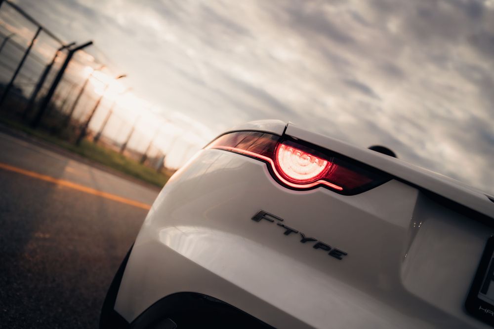 Close-up of white Jaguar F-Type tail light at sunset. Mtlshutter photography