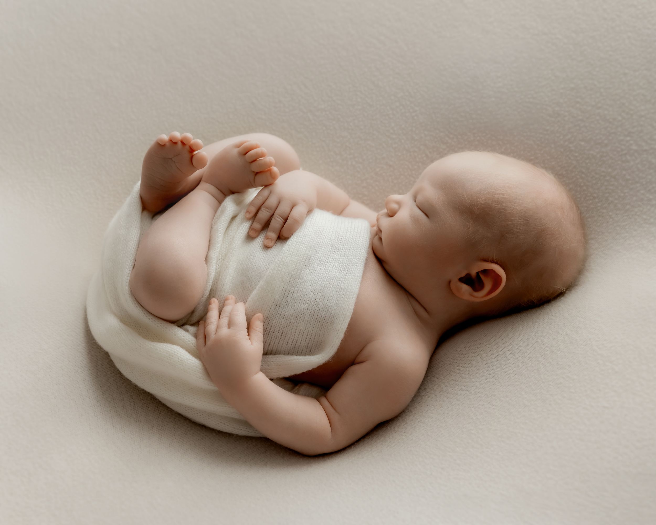 Newborn baby peacefully sleeping during photography session